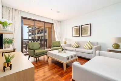 a living room with a couch and a table at Lux BnB I Palm Jumeirah Resort I Palm Views in Dubai