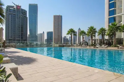a large swimming pool in a city with tall buildings at Frank Porter - Prive A in Dubai