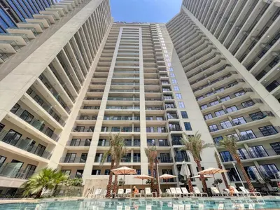 a large building with a pool in front of it at GuestReady - A sophisticated and refined dwelling in Dubai