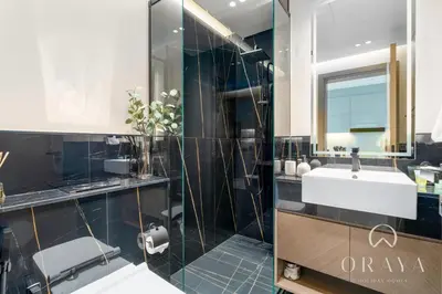 a bathroom with a sink and a mirror at Oraya - Studio With Jaw-Dropping Canal and Burj Views - Business bay in Dubai