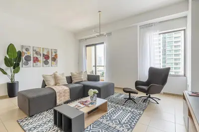 a living room with a couch and a table at Frank Porter - Bahar 1 in Dubai
