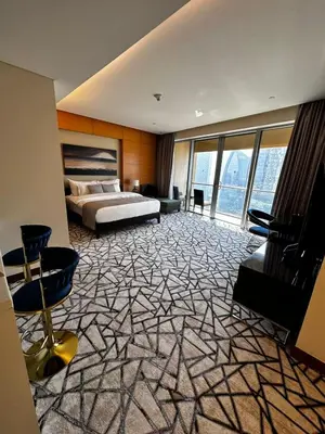 a large bedroom with a bed and a large window at Fashion Avenue Dubai Mall Burj Khalifa View Residence- Formerly Address Dubai Mall in Dubai
