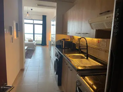 a kitchen with a sink and a counter top at Studio in Silicon Oasis in Dubai
