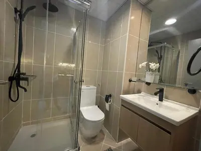 a bathroom with a shower and a toilet and a sink at Studio in Silicon Oasis in Dubai