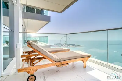 a bed on a balcony with a view of the ocean at Picturesque 3BR with Assistant Room at The One JBR by Deluxe Holiday Homes in Dubai
