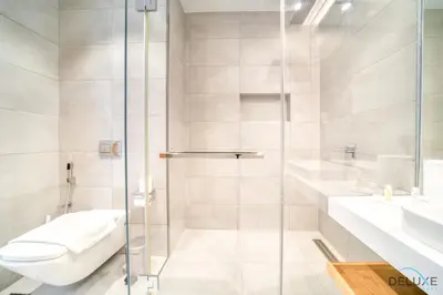a bathroom with a shower and a toilet and a sink at Picturesque 3BR with Assistant Room at The One JBR by Deluxe Holiday Homes in Dubai