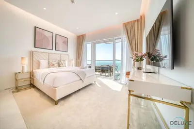a white bedroom with a bed and a large window at Picturesque 3BR with Assistant Room at The One JBR by Deluxe Holiday Homes in Dubai