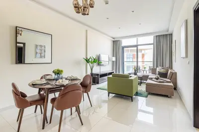 a living room with a table and chairs and a couch at Frank Porter - Damac Celestia in Dubai