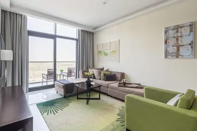 a living room with a couch and a table at Frank Porter - Damac Celestia in Dubai