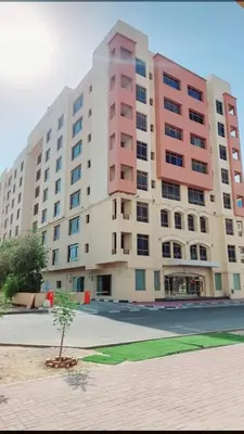 a large building with a tree in front of it at Havana Holiday Homes Oud Metha in Dubai