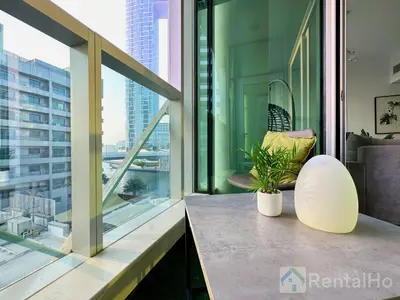 a balcony with a table and a plant on it at Lxry Full Marina View & RoofTop Pool 40% OFF in Dubai