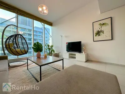 a living room with a couch and a table and a tv at Lxry Full Marina View & RoofTop Pool 40% OFF in Dubai