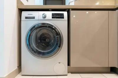 a white washing machine sitting in a kitchen at Serenity Studio in Dubai