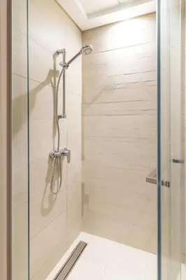 a shower with a glass door in a bathroom at Modern Stu Near Downtown Dubai Pool Gym WiFi in Dubai