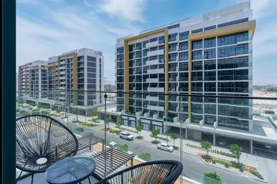 a balcony with chairs and a view of buildings at Modern Stu Near Downtown Dubai Pool Gym WiFi in Dubai