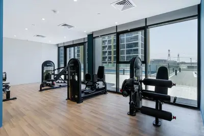 a gym with several treadmills and a large window at Modern Stu Near Downtown Dubai Pool Gym WiFi in Dubai