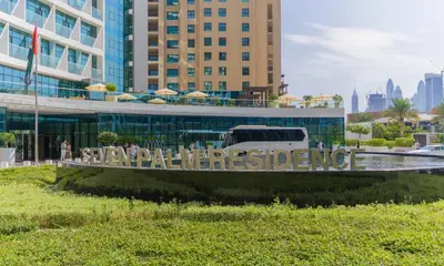 a white van parked in front of a building at Studio with private beach access at Palm Jumeirah in Dubai