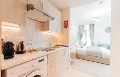 a kitchen with a sink and a bed in a room at Studio with private beach access at Palm Jumeirah in Dubai