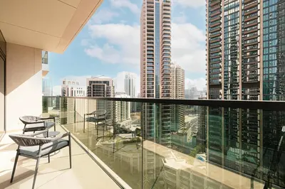 a balcony with chairs and a view of a city at HomesGetaway -Lavish 1BR in ACT One Downtown Dubai in Dubai