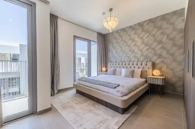 a bedroom with a large bed and a large window at Exclusive Spacious Villa I Garden I Maid Room in Dubai