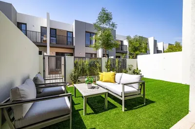 an apartment patio with chairs and a table at Exclusive Spacious Villa I Garden I Tilal Al Ghaf in Dubai