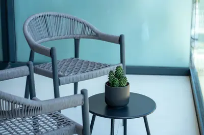 a plant sitting on a table next to a chair at Keyrock Living - Lakeview Escape in Business Bay in Dubai