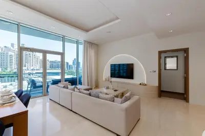 a living room with a couch and a tv at Oceana Residences, Oceana Palm Jumeirah - Mint Stay in Dubai