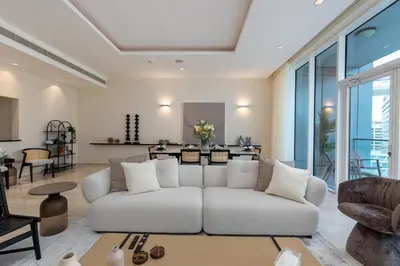 a living room with a white couch and a table at Oceana Residences, Oceana Palm Jumeirah - Mint Stay in Dubai
