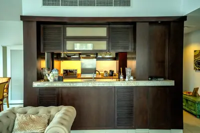 a kitchen with a bar with a counter top at Elegant Apartment Overlooking Dubai Mall Fountain. in Dubai