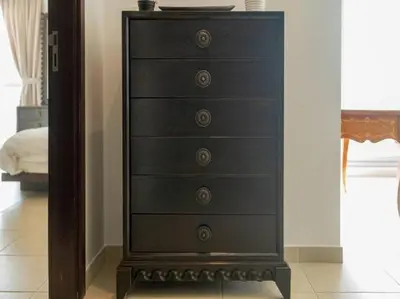 a black dresser with four drawers in a room at Elegant Apartment Overlooking Dubai Mall Fountain. in Dubai