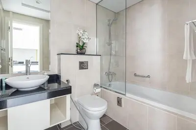 a bathroom with a sink and a toilet and a tub at Frank Porter - DAMAC Artesia in Dubai