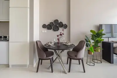 a dining room with a table and two chairs at Frank Porter - DAMAC Artesia in Dubai