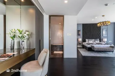 a living room with a bed and a dining room at Seaside Splendor The Palm's Breathtaking View in Dubai