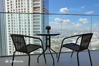 two chairs and a table on the balcony of a building at Luxurious 1 Bed with Direct Access to Dubai Mall in Dubai