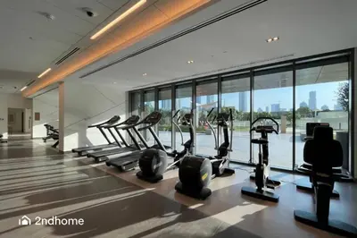 a gym with treadmills and ellipticals in a building at Luxurious 1 Bed with Direct Access to Dubai Mall in Dubai