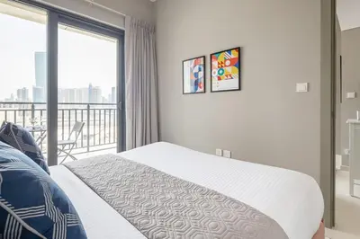 a bedroom with a bed and a balcony at Frank Porter - Zada Tower in Dubai