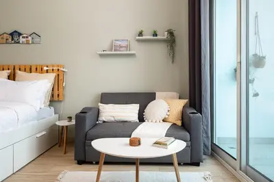 a living room with a couch and a bed at Studio With Best View Of Dubai in Dubai