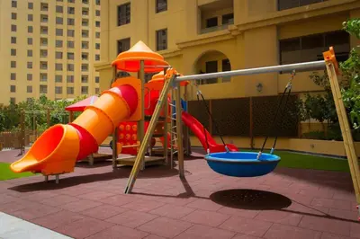 a playground with a slide and a slideintend at Jumeirah Beach Residence - Bahar 6, Dubai Marina in Dubai