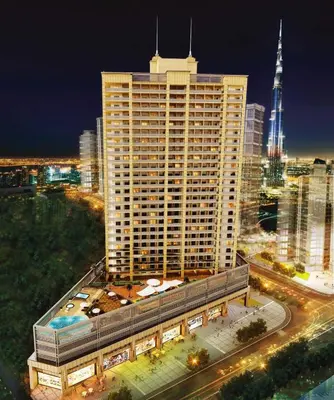 a large building in a city at night at Daniels Cityscape Studio at Elite Downtown in Dubai