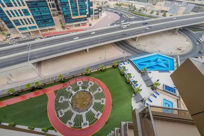 an overhead view of a highway and a building with a wheel at Daniels Cityscape Studio at Elite Downtown in Dubai