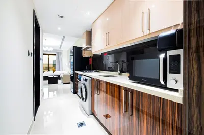 a kitchen with a sink and a microwave at Daniels Cityscape Studio at Elite Downtown in Dubai