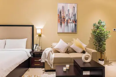 a hotel room with a bed and a couch at Daniels Cityscape Studio at Elite Downtown in Dubai