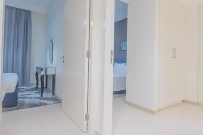 a room with white cabinets and a bed and a mirror at BellaVista Downtown Views II T1 - 2 bedroom apartment with Burj Khalifa View in Dubai