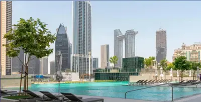 a large swimming pool in a city with buildings at BellaVista Downtown Views II T1 - 2 bedroom apartment with Burj Khalifa View in Dubai