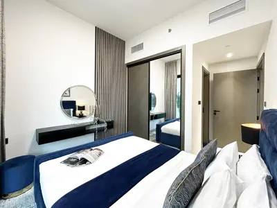 a bedroom with a bed and a mirror at Trophy Lux Suite With Garden Balcony and Burj Khalifa Views in Dubai