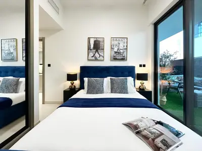 a bedroom with a large bed and a large window at Trophy Lux Suite With Garden Balcony and Burj Khalifa Views in Dubai