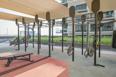 a gym with weights on the roof of a building at Urban Skyline City Comfort Studio in Dubai