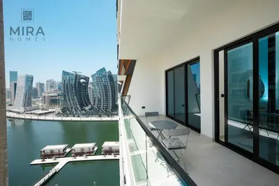 a balcony of a building with a view of the city at Mira Holiday Homes - Serviced 1 bedroom with canal view in Dubai