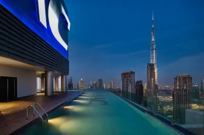 a swimming pool on the roof of a building with a city skyline at Daniels Burj Khalifa View 2BR at Paramount Midtown in Dubai