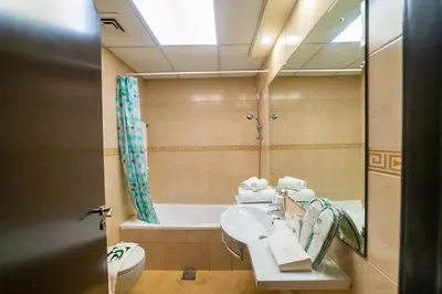 a bathroom with a sink and a bath tub at 1BR Spacious Apartment in Marina Sail By PK Holidays in Dubai